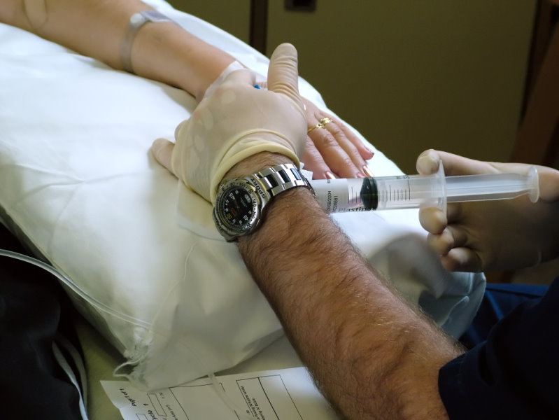 Doctor making injection with syringe