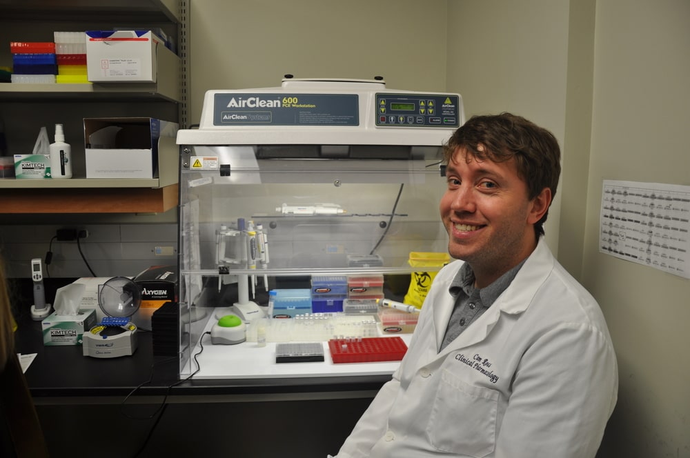 Cameron Ross sitting in the genotyping lab