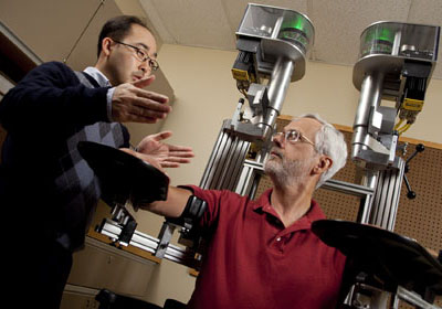 Scientists discussing robotic system KINARM